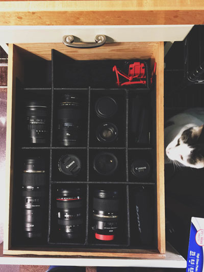 Camera equipment storage - old shelf converted into easy lens and camera storage.