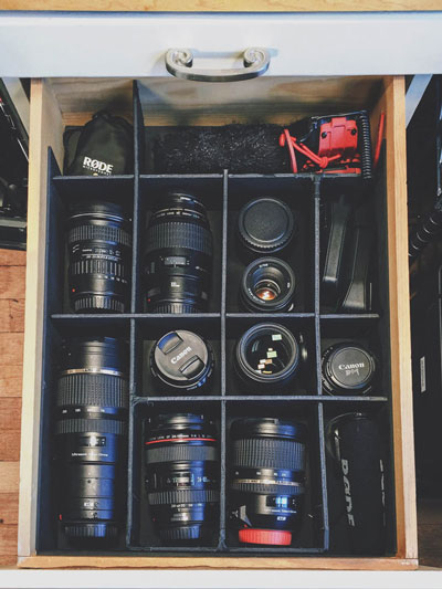 Camera equipment storage - old shelf converted into easy lens and camera storage. 
